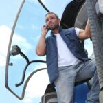 farmer on his tractor talking on the phone